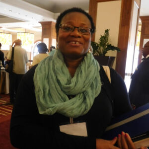 woman with glasses smiling at the camera